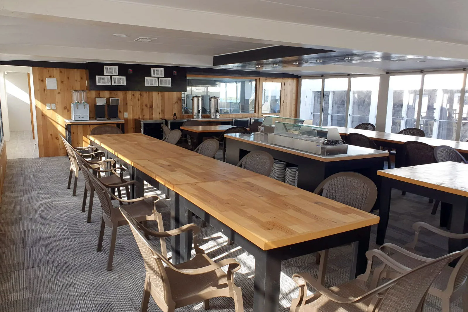 Dining saloon with a long wooden table and buffet counter