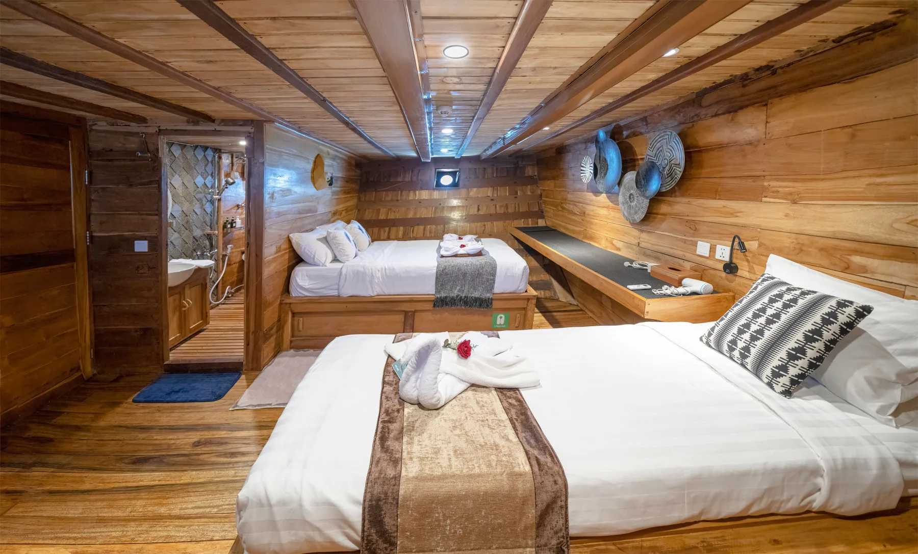 The roomy Deluxe cabin on Komodo Aggressor with a queen bed and a separate single