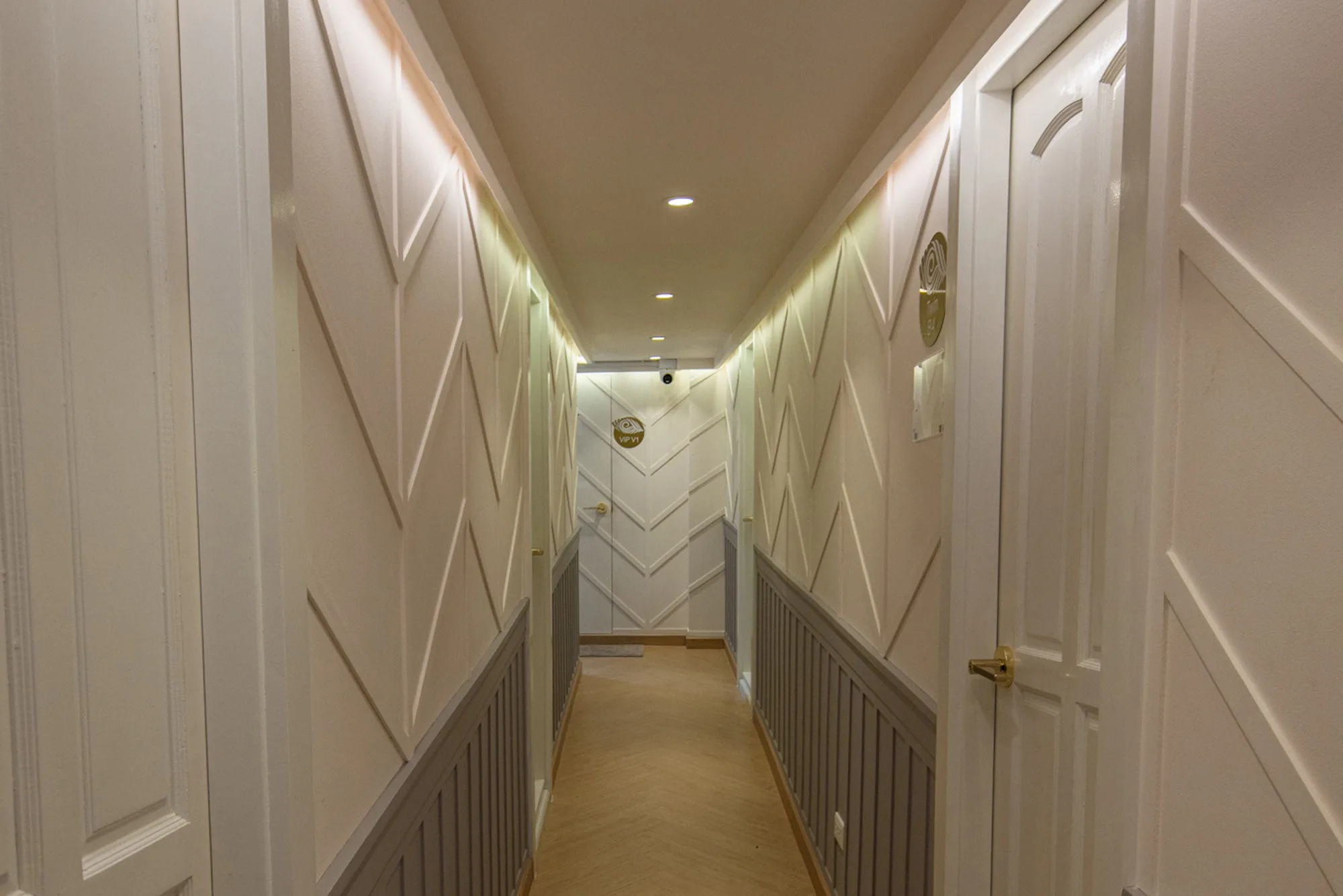 Cabin corridor on Krishna 3 with pale panelling and concealed lighting