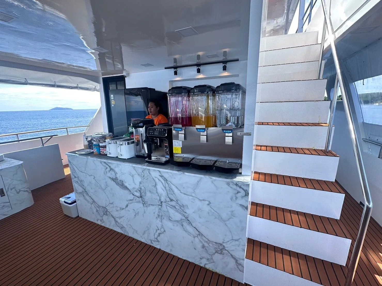 Bar with a coffee machine and drinks beside the deck stairs