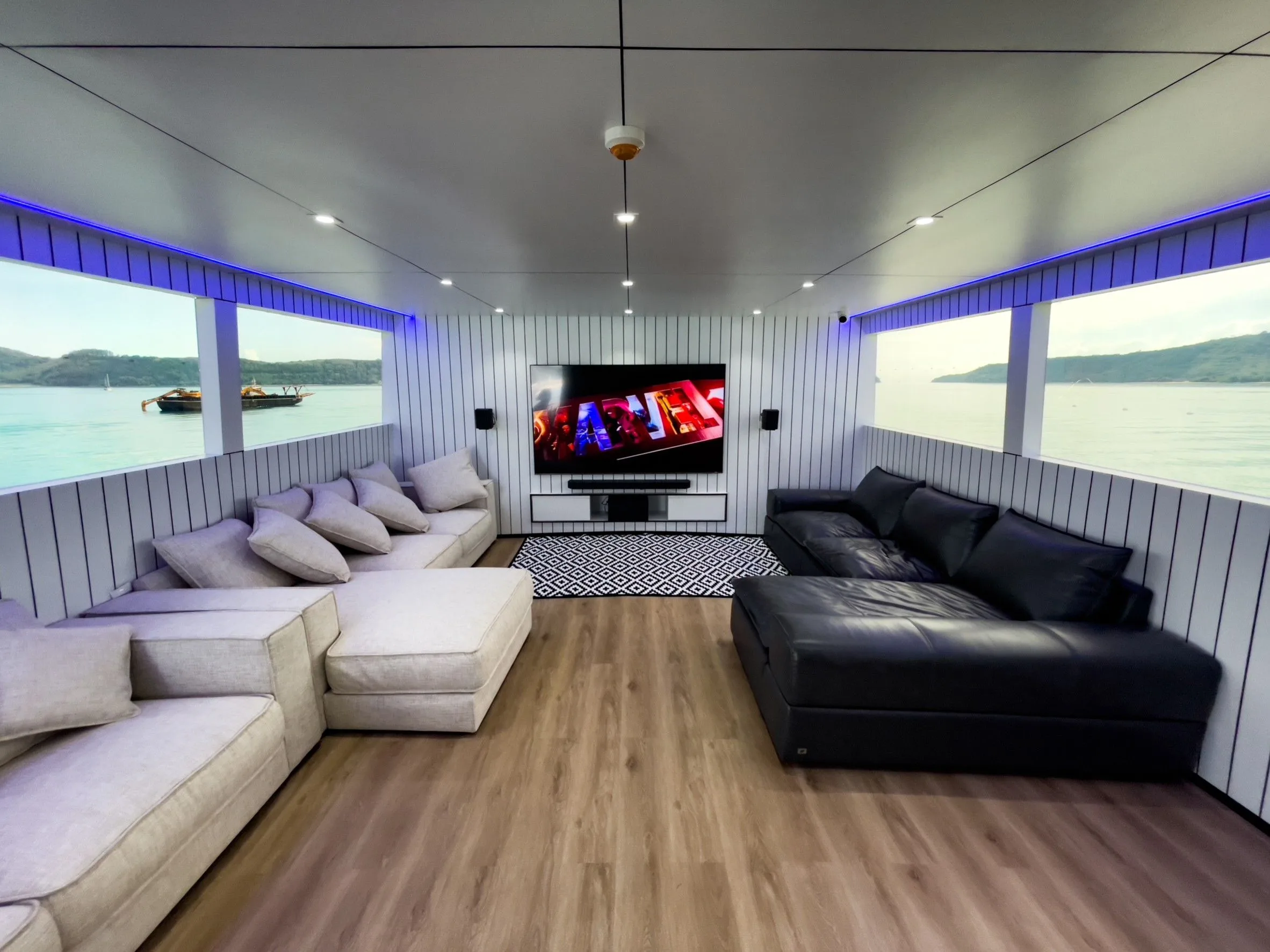 Air-conditioned saloon with sofas and a big screen