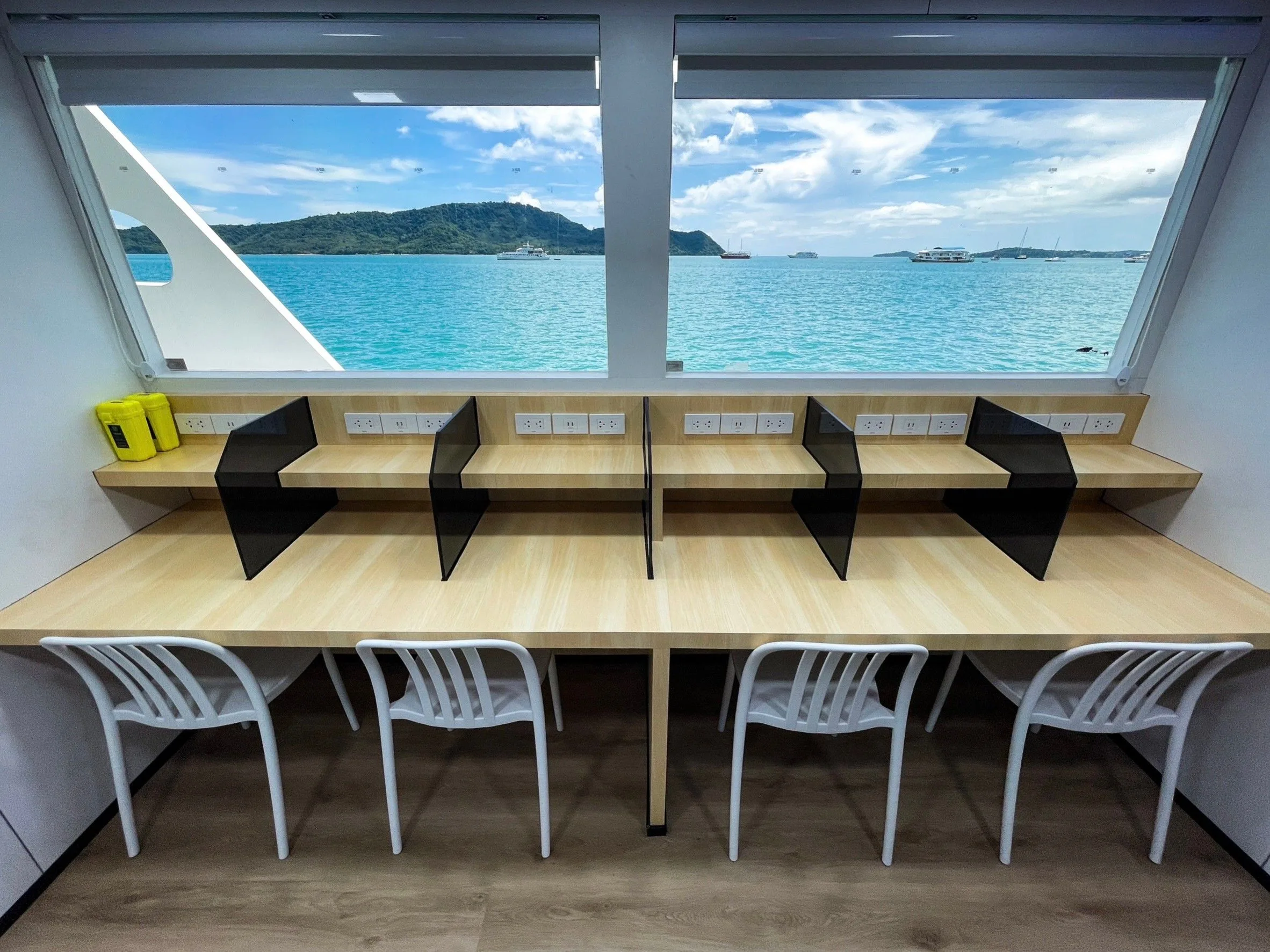 Camera room with workstations, power sockets and windows onto the sea