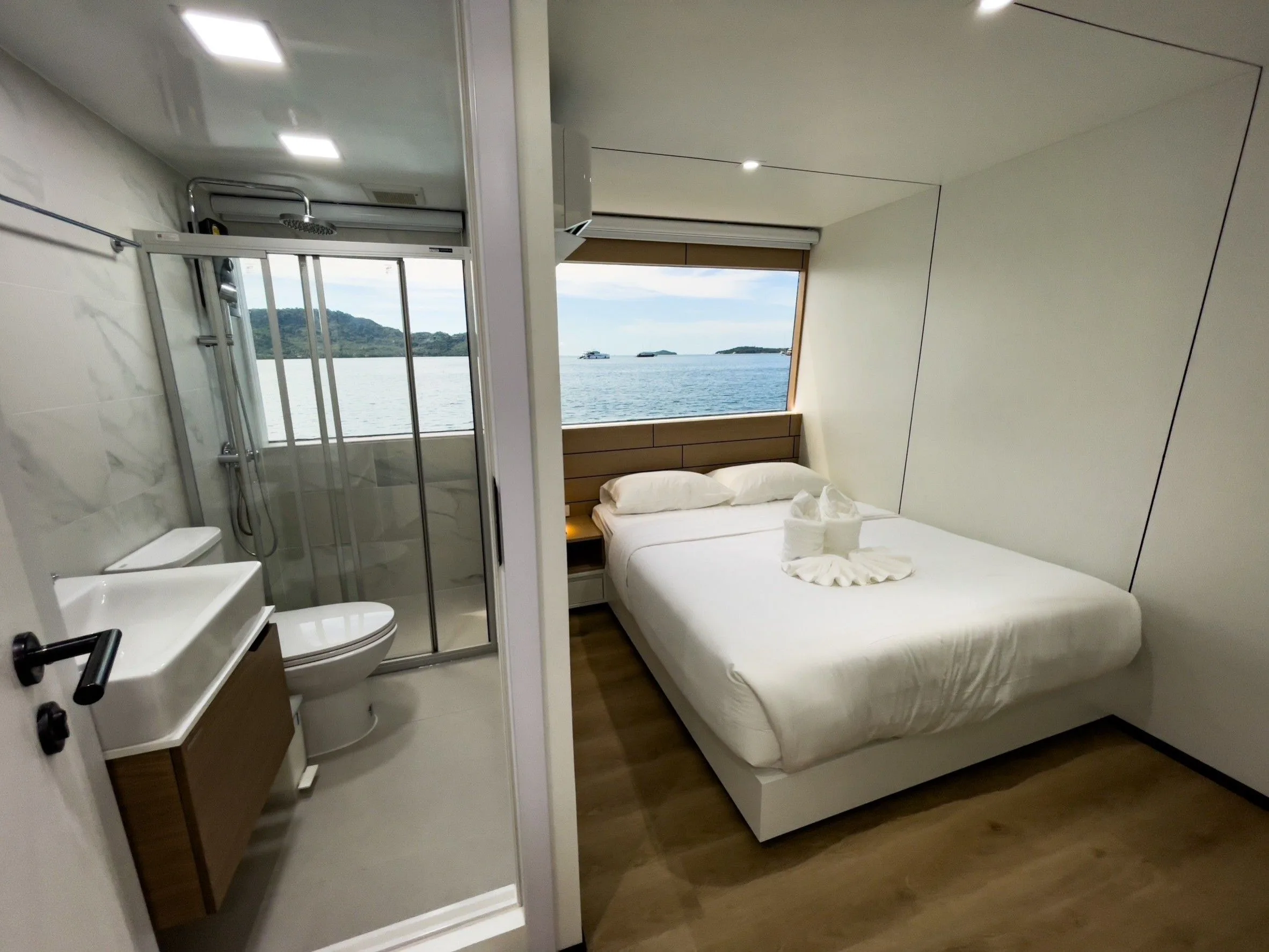 Upper deck master cabin — double bed, shower and a window onto the sea