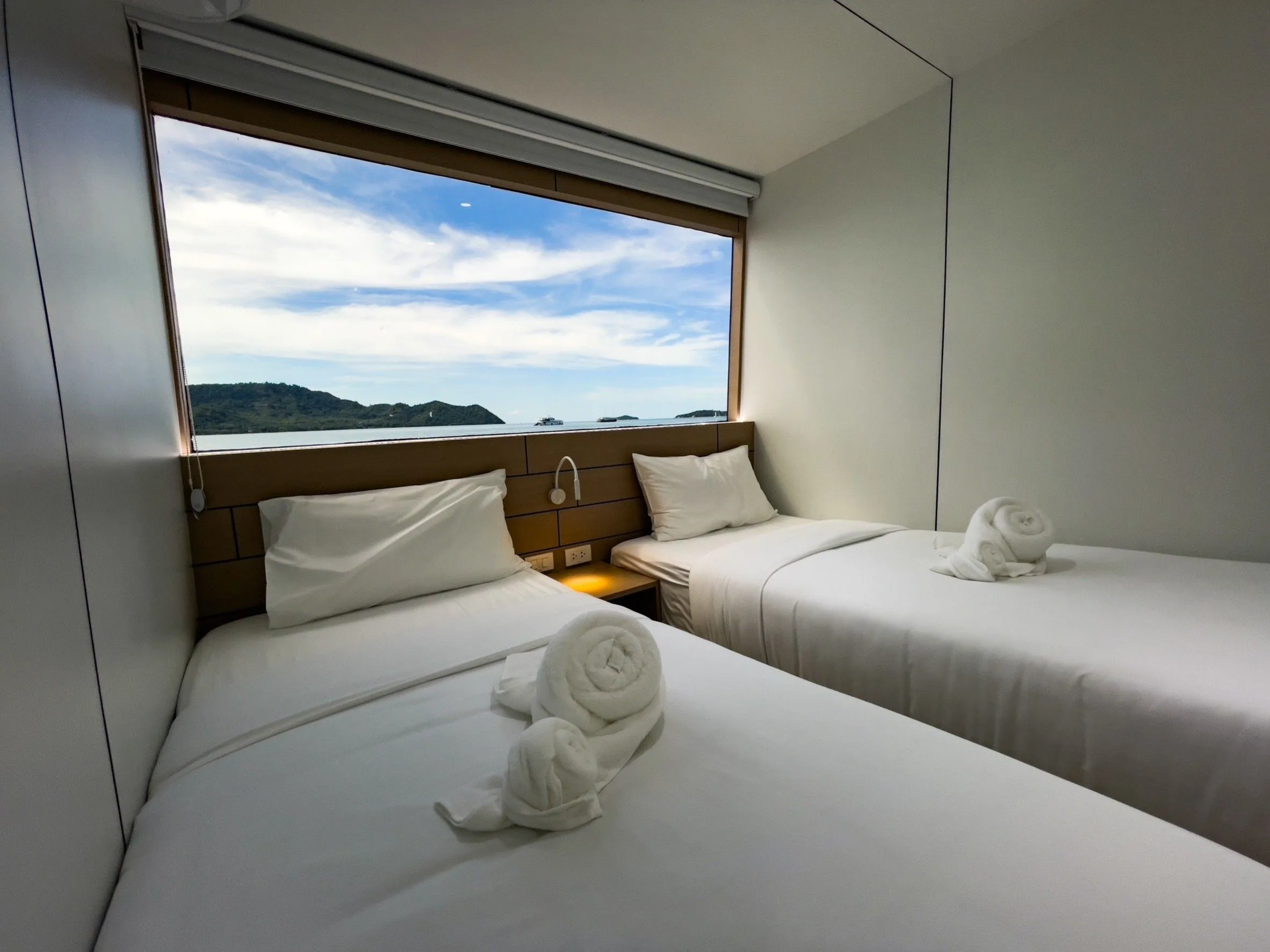 Upper deck twin cabin — separate beds by a large window
