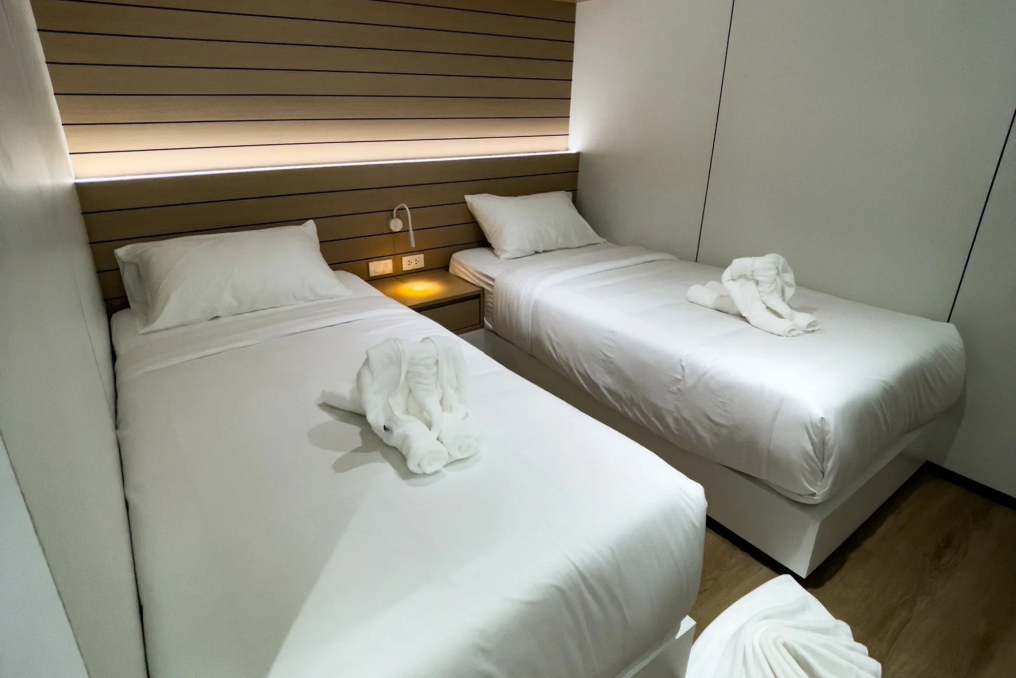 Lower deck twin cabin with a wooden headboard