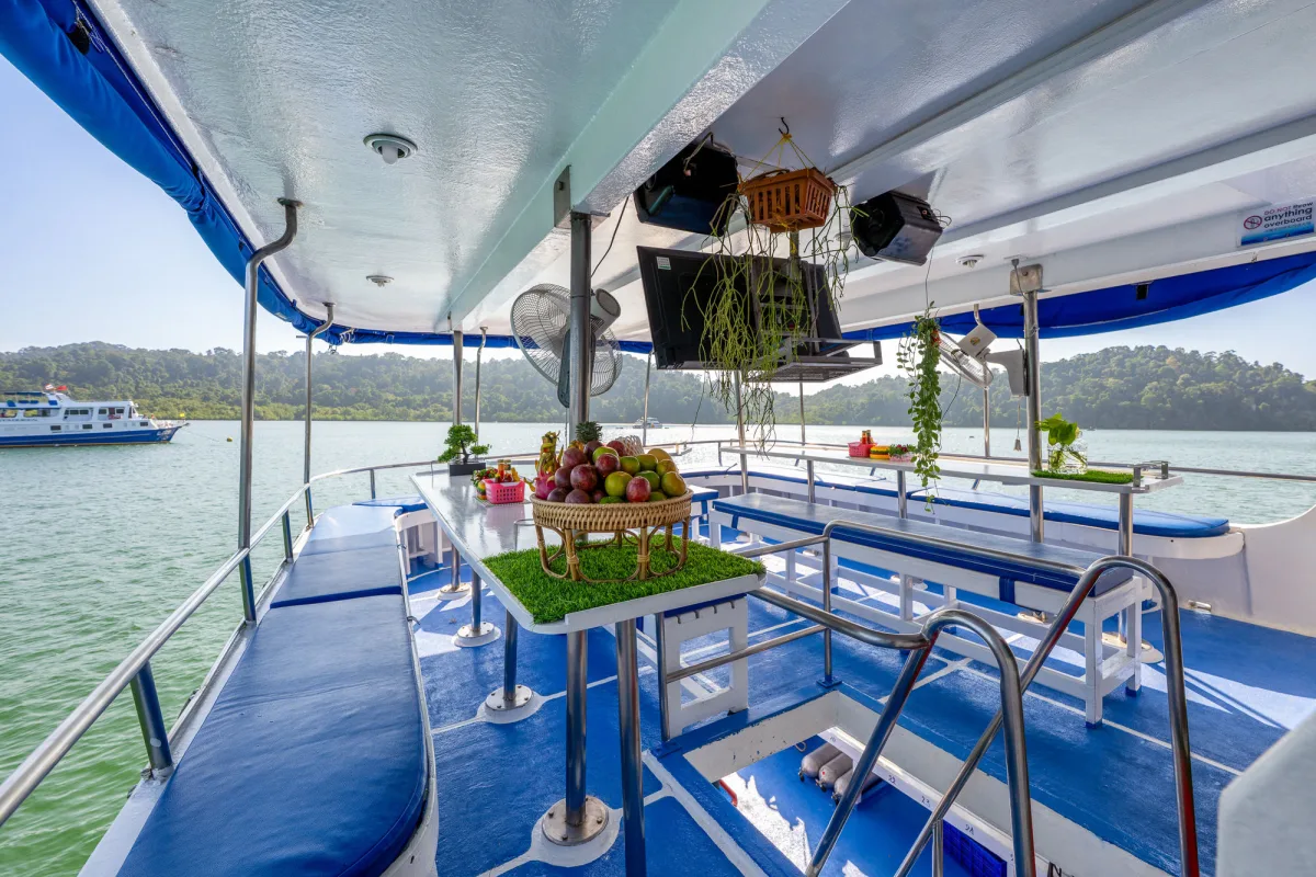 Open-air dining area with a basket of fresh fruit