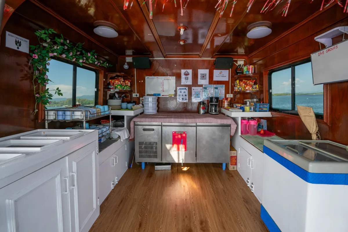 Galley and buffet area of Manta Queen 2 with a wooden ceiling