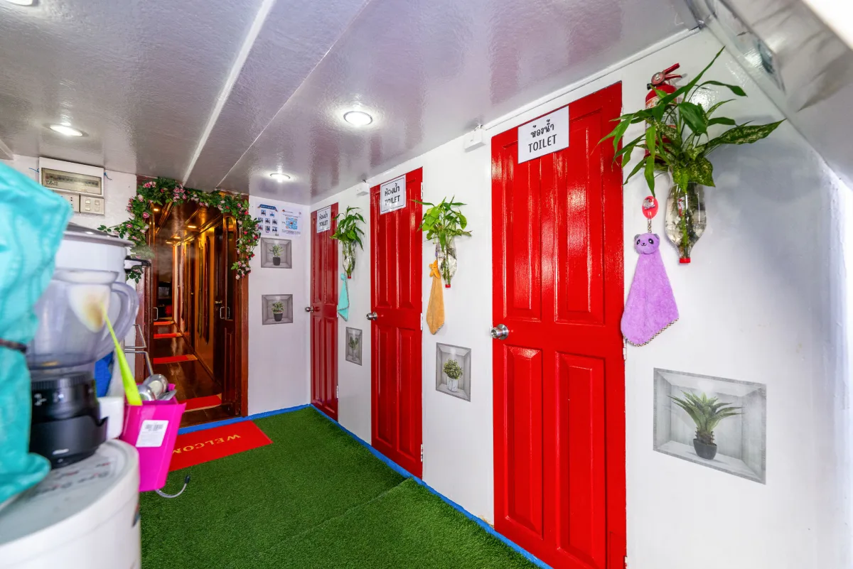 Shared showers and toilets on Manta Queen 2 behind red doors