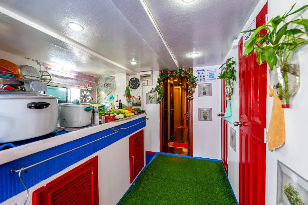 Corridor with the galley and shared bathrooms on Manta Queen 2