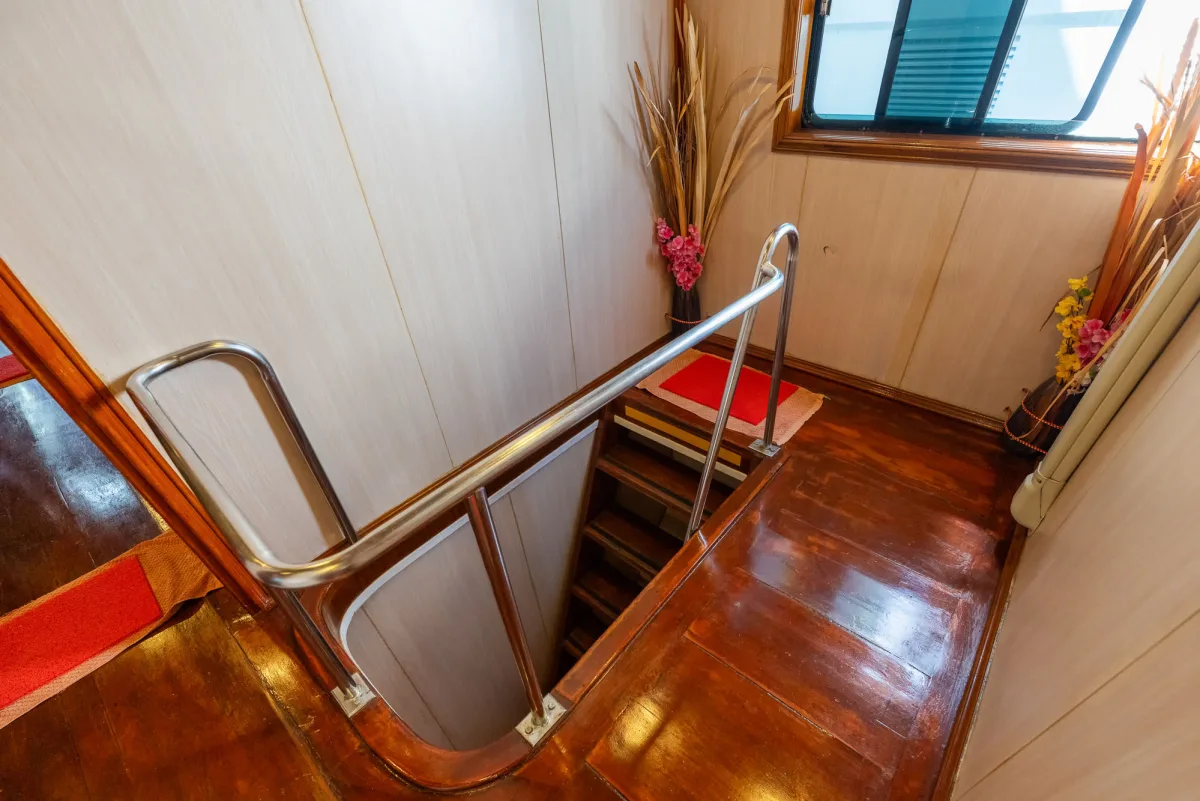 Staircase between decks on Manta Queen 2 with wooden finish