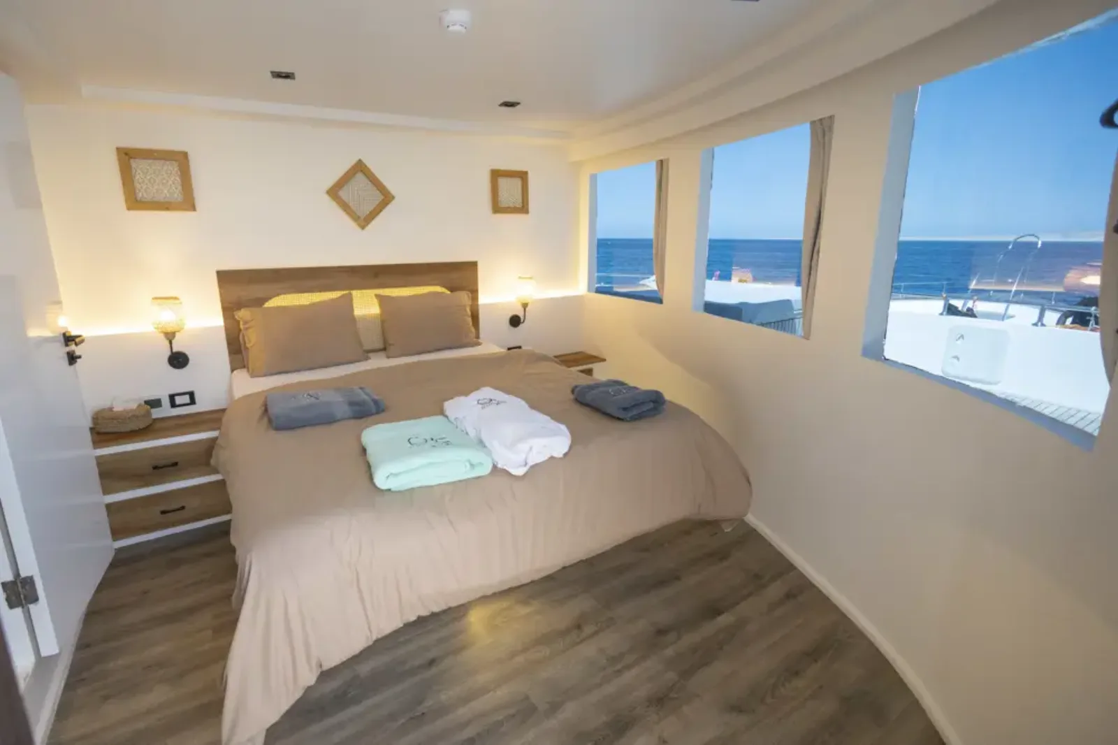 Panorama suite on Ocean Lovers — double bed and windows along the bow shoulder