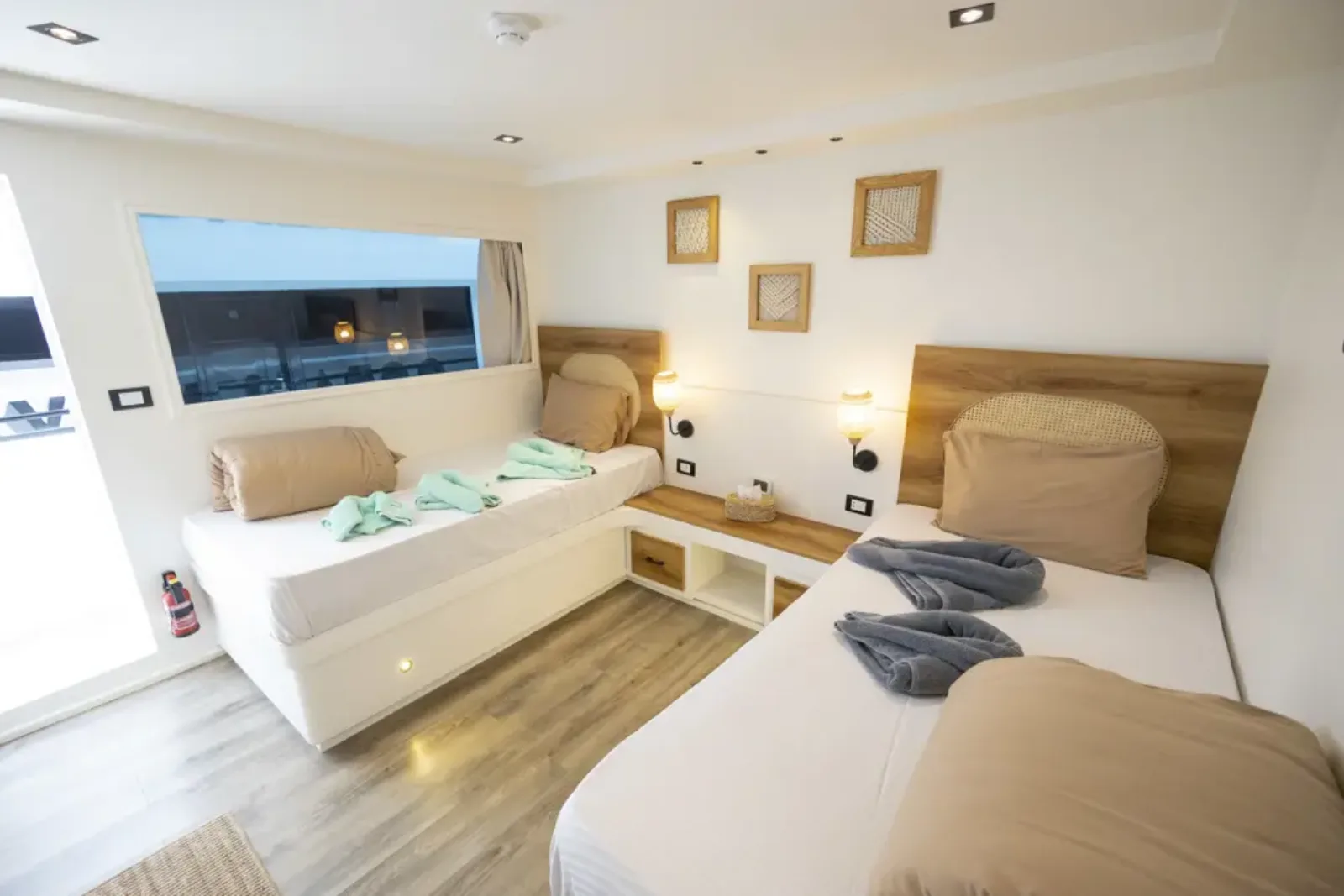 Twin cabin on the sun deck of Ocean Lovers — separate beds beside a panoramic window