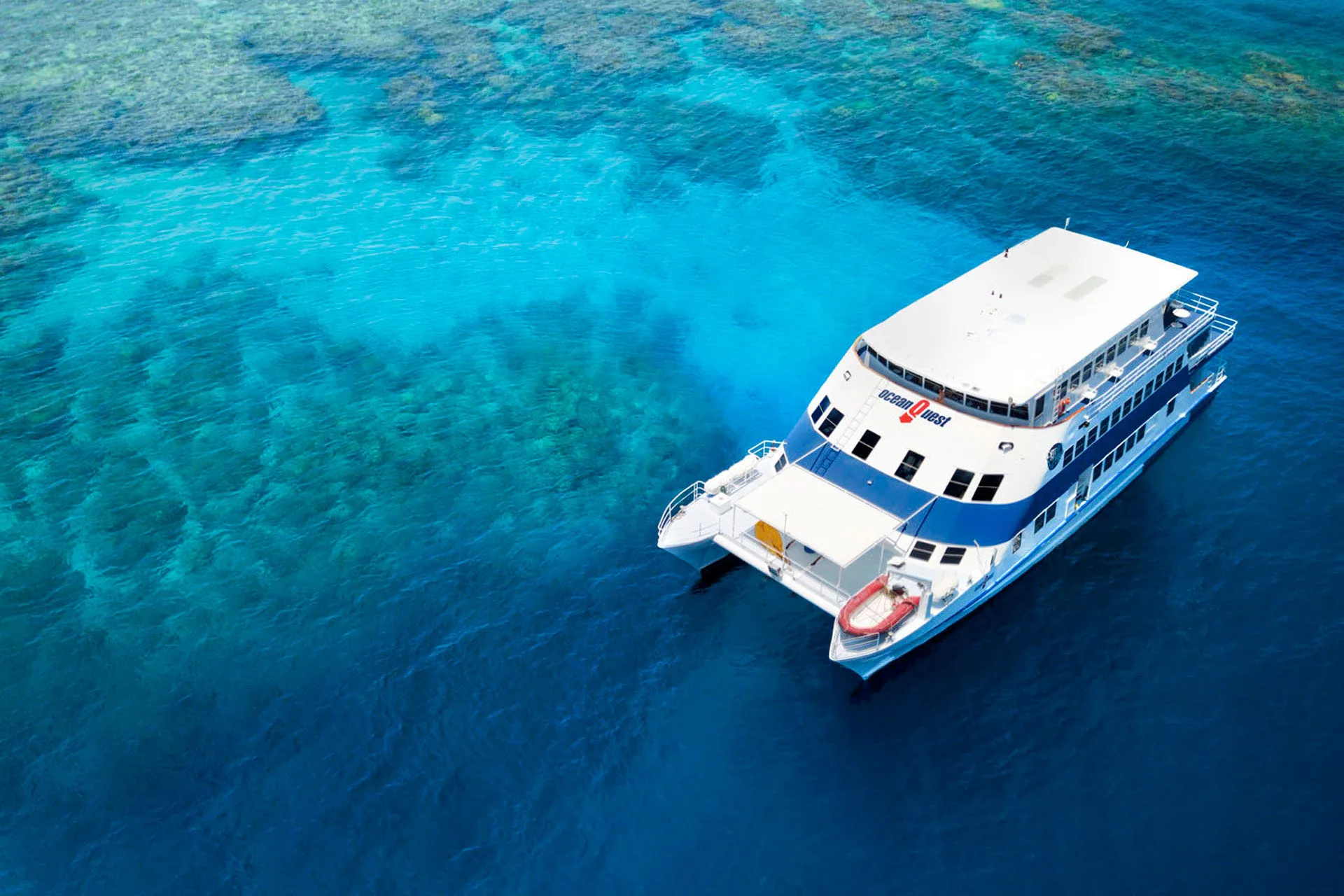 Ocean Quest on its permanent mooring above the turquoise Great Barrier Reef, seen from the air