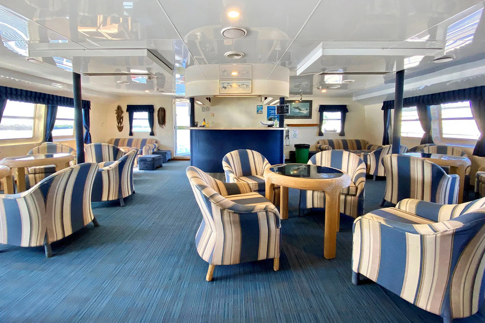Air-conditioned saloon with armchairs and the bar