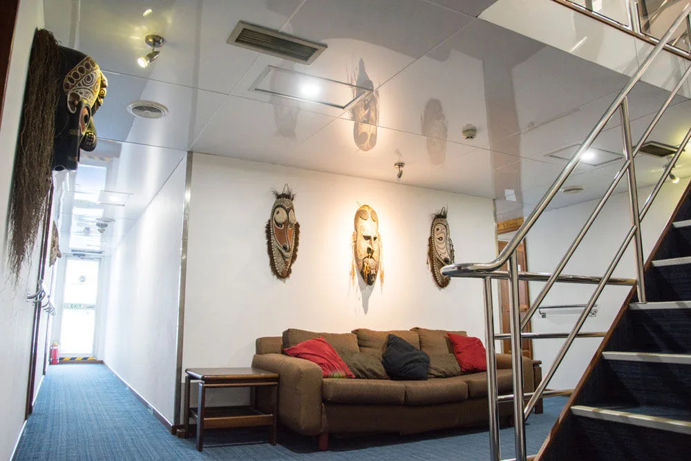 Lounge area with a sofa and the stairway between decks