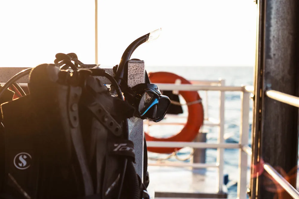 Assembled dive gear on deck against the morning sun