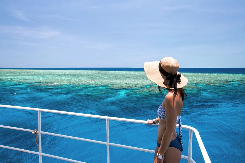 Guest on the foredeck looking down at the coral below