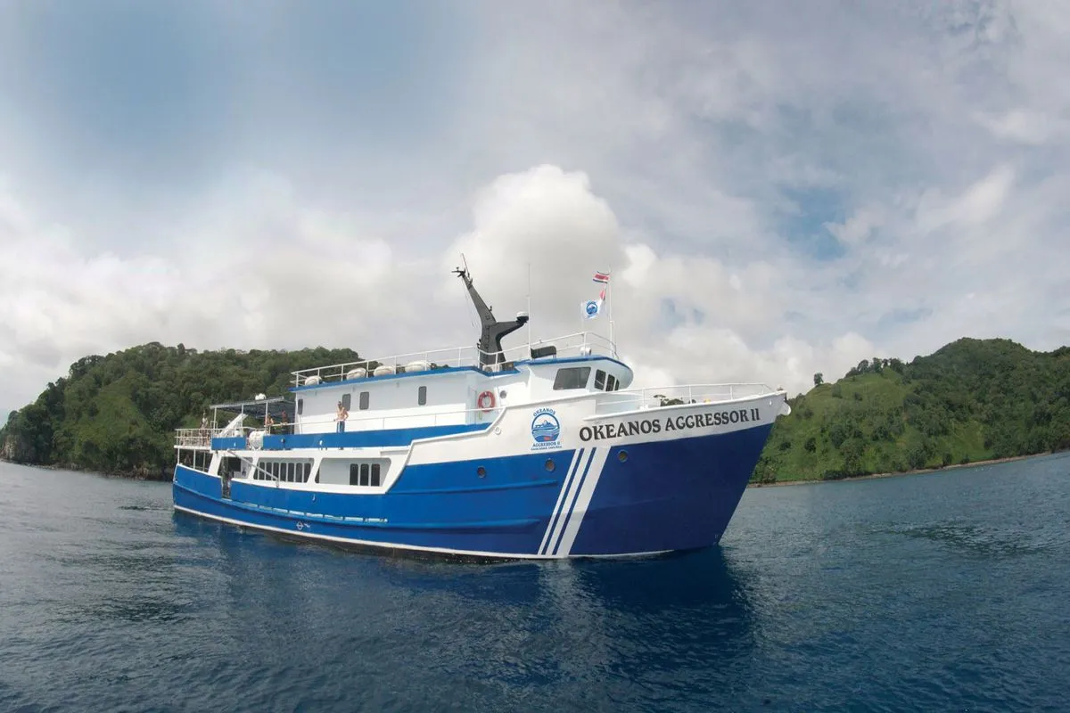 Okeanos Aggressor II anchored off the green shores of Cocos Island
