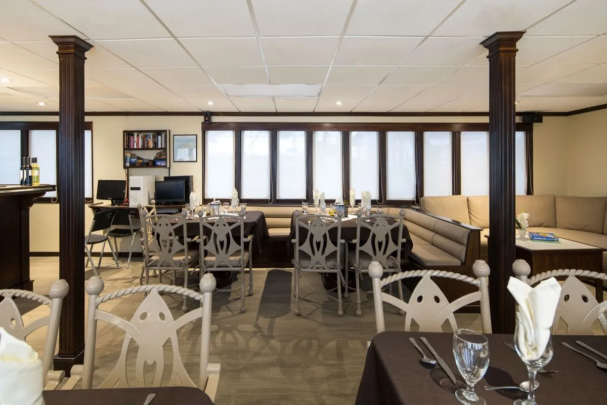 Tables by the panoramic windows in the Okeanos Aggressor II restaurant