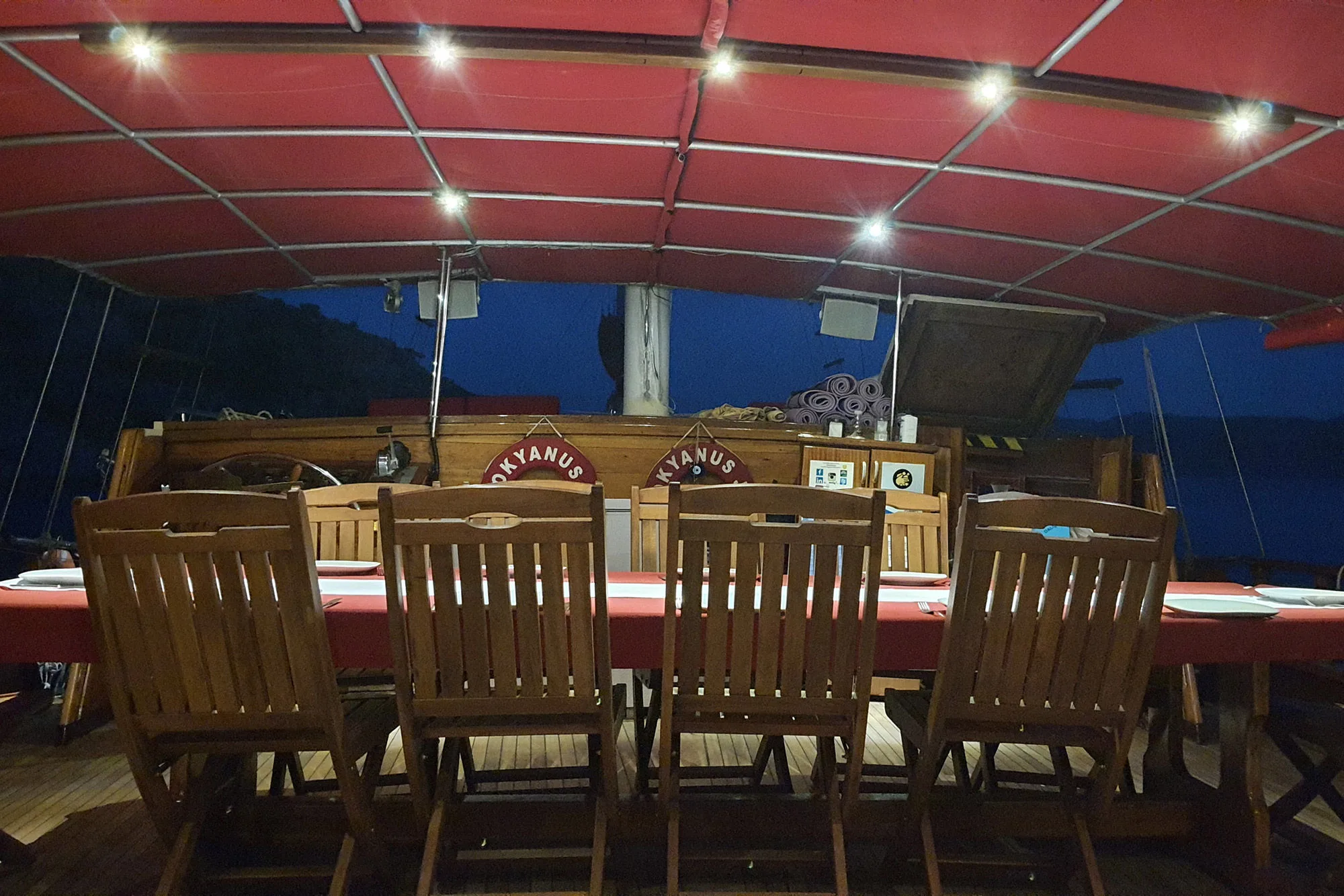 Dinner on the aft deck under the lit awning hung with lifebuoys