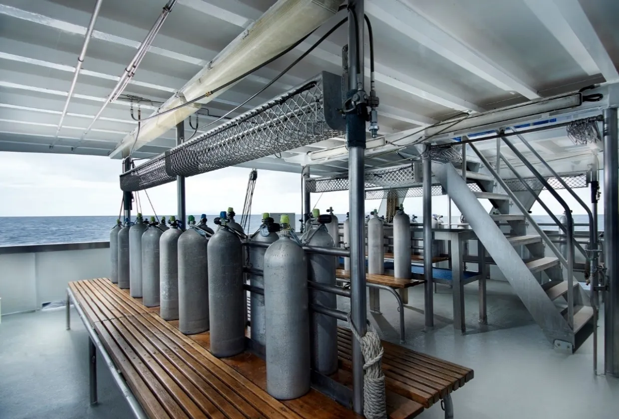 Cylinders racked on the dive deck of Pacific Master