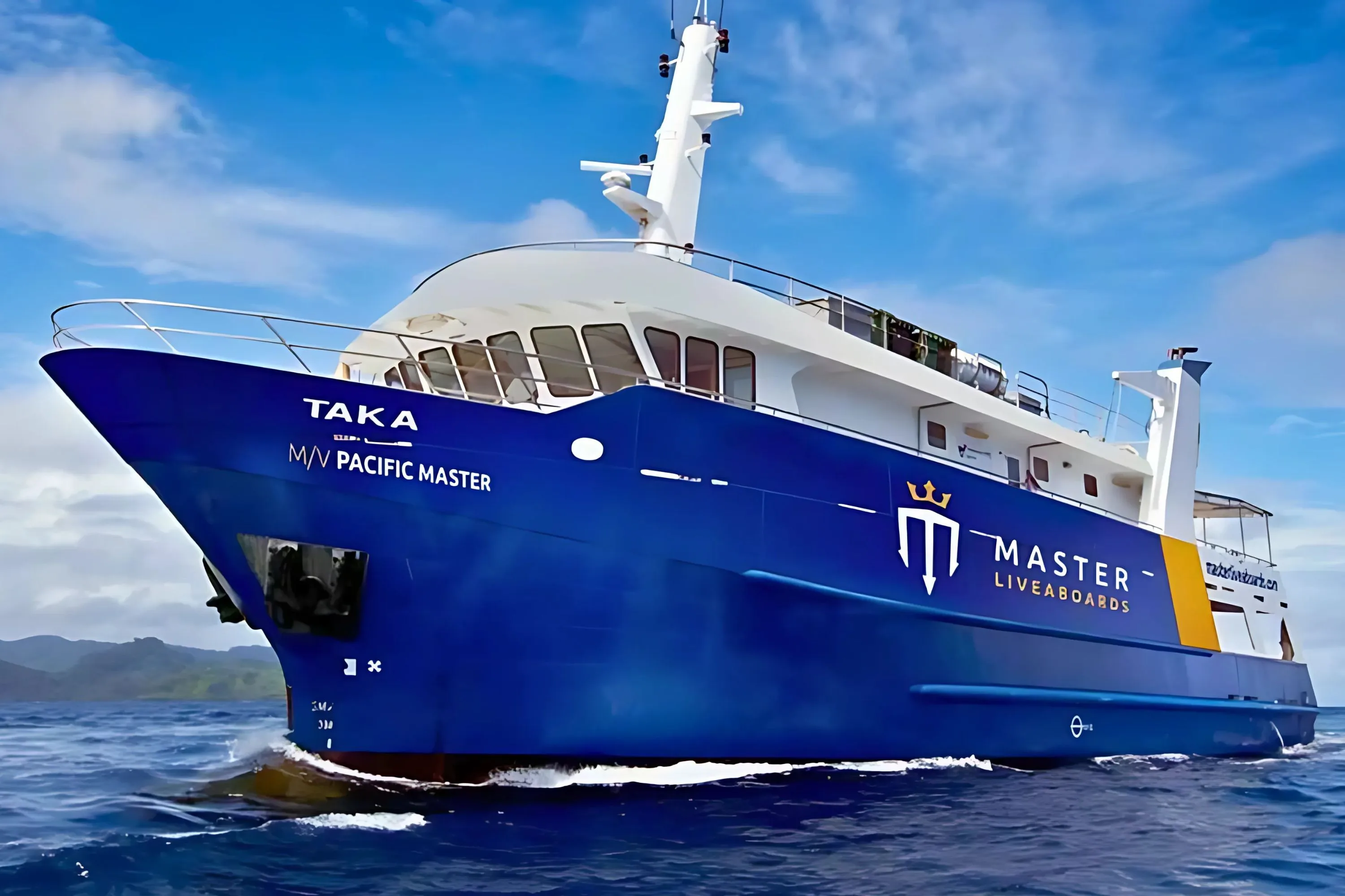 Pacific Master at sea — blue hull lettered TAKA with the Master Liveaboards emblem