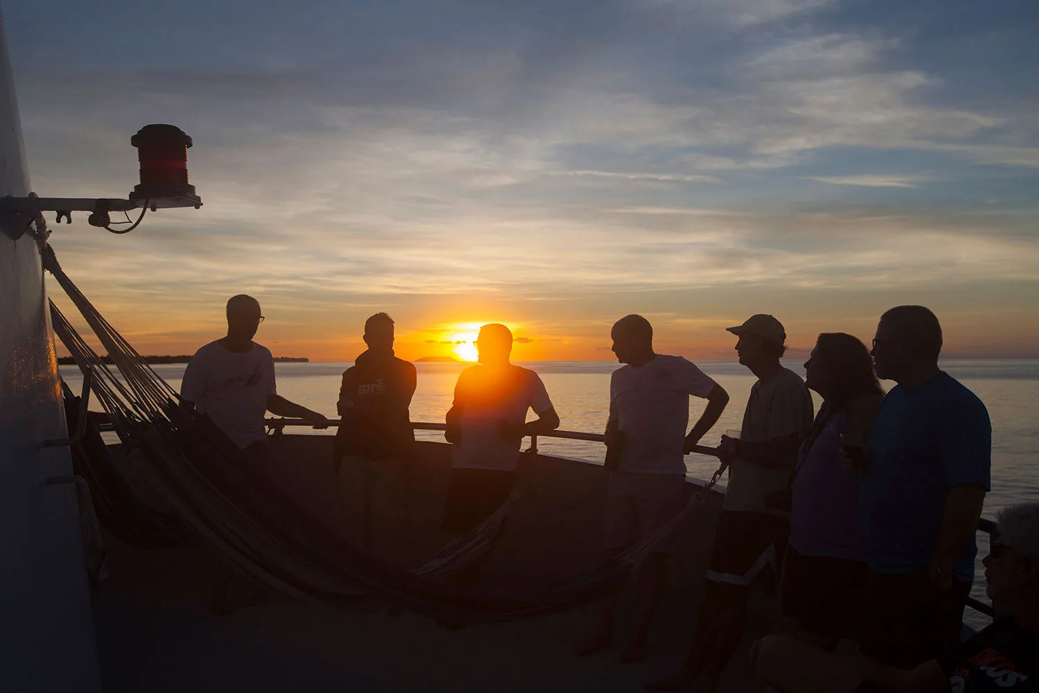 Sunset from the deck of Pacific Master with guests at the rail