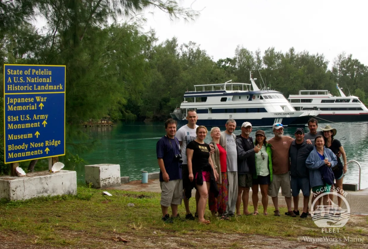Guests ashore on Peleliu by the memorial signpost