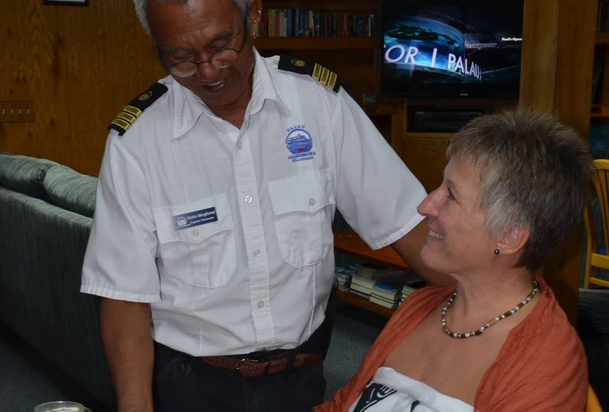 The Palau Aggressor II captain with a guest in the saloon
