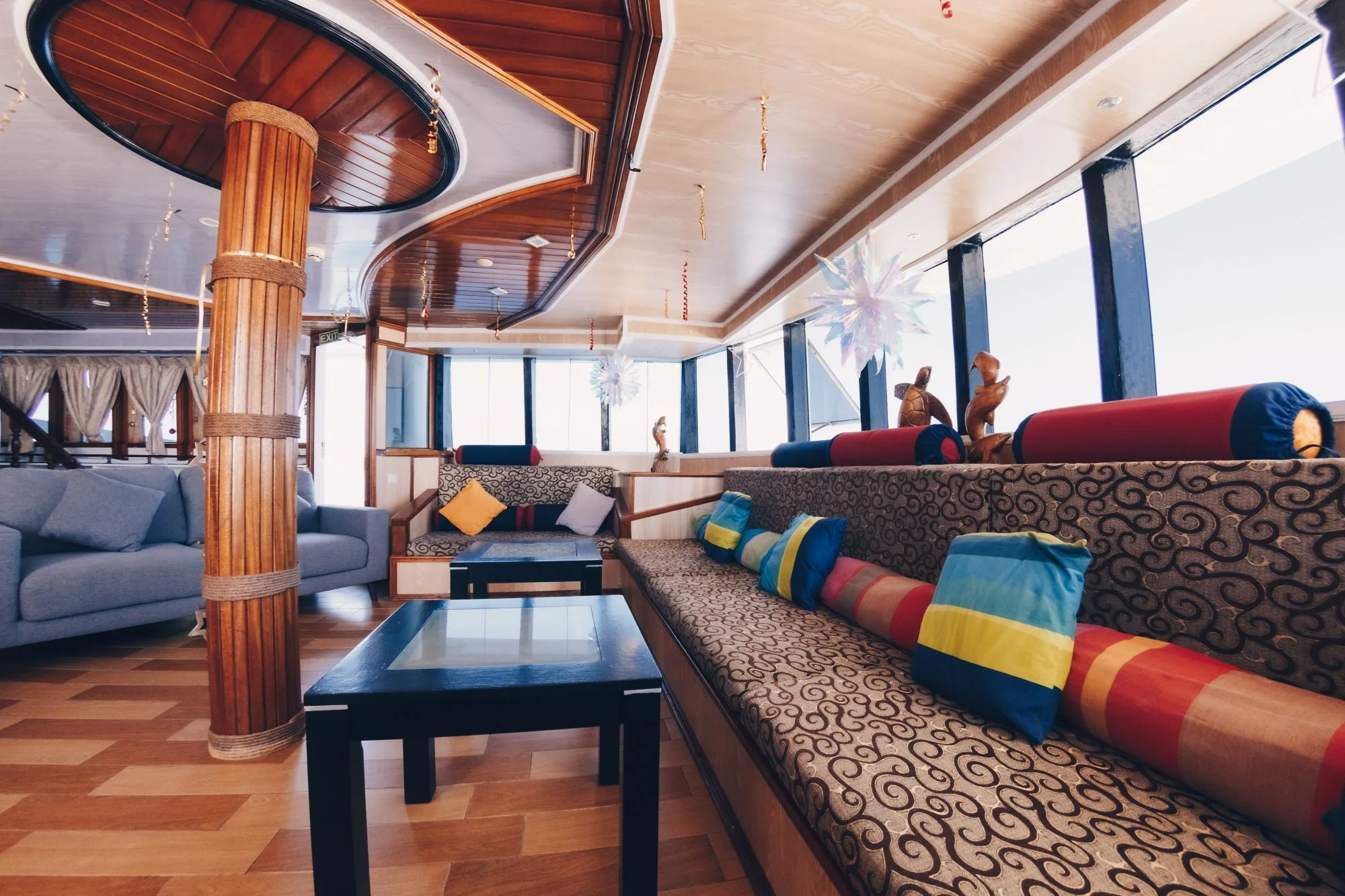 Lounge on Princess Dhonkamana with colourful cushions and panoramic windows