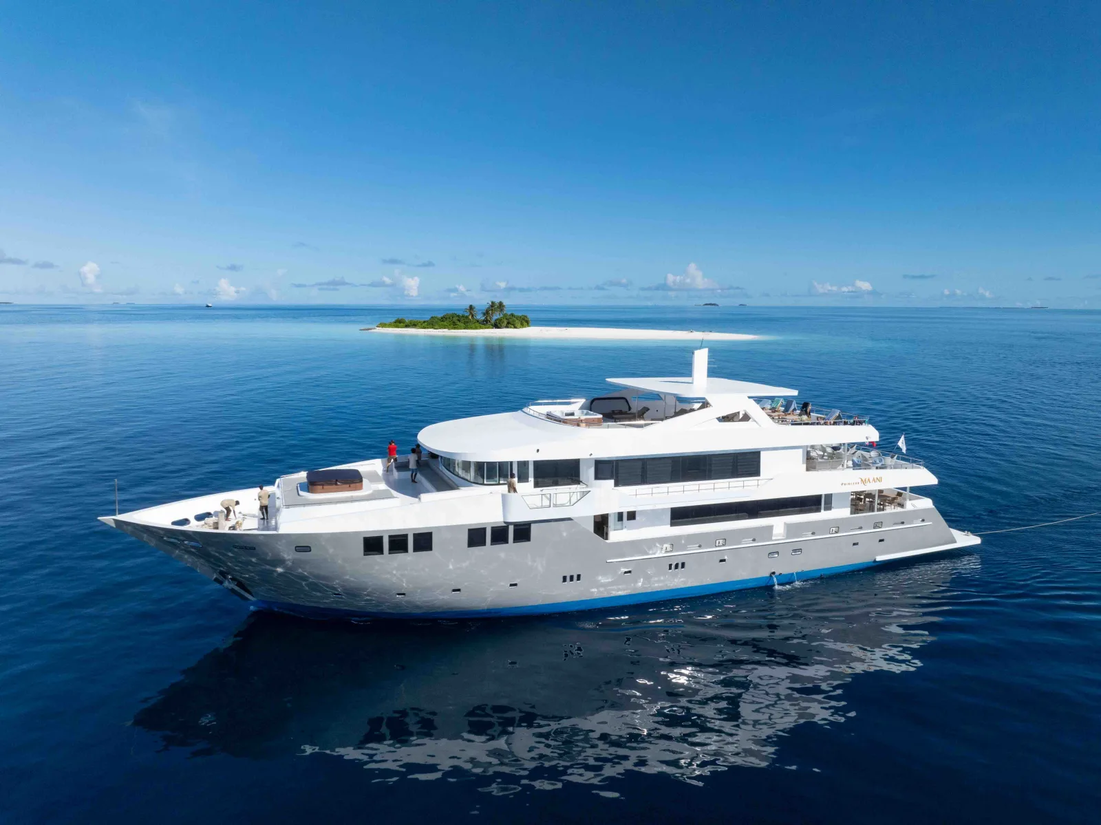 Princess Maani anchored off a deserted island, seen from the air