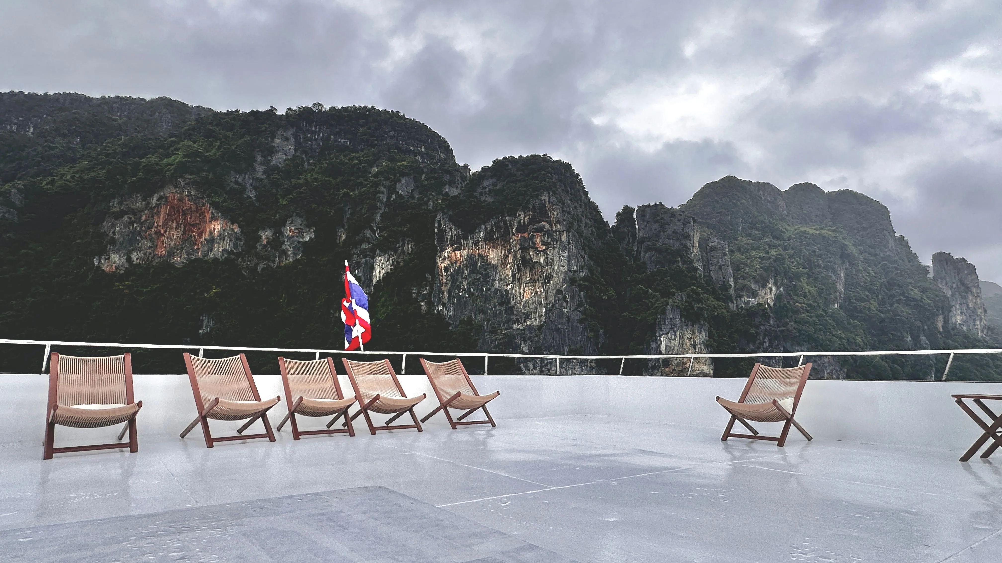 Raga sun deck with loungers and limestone cliffs behind