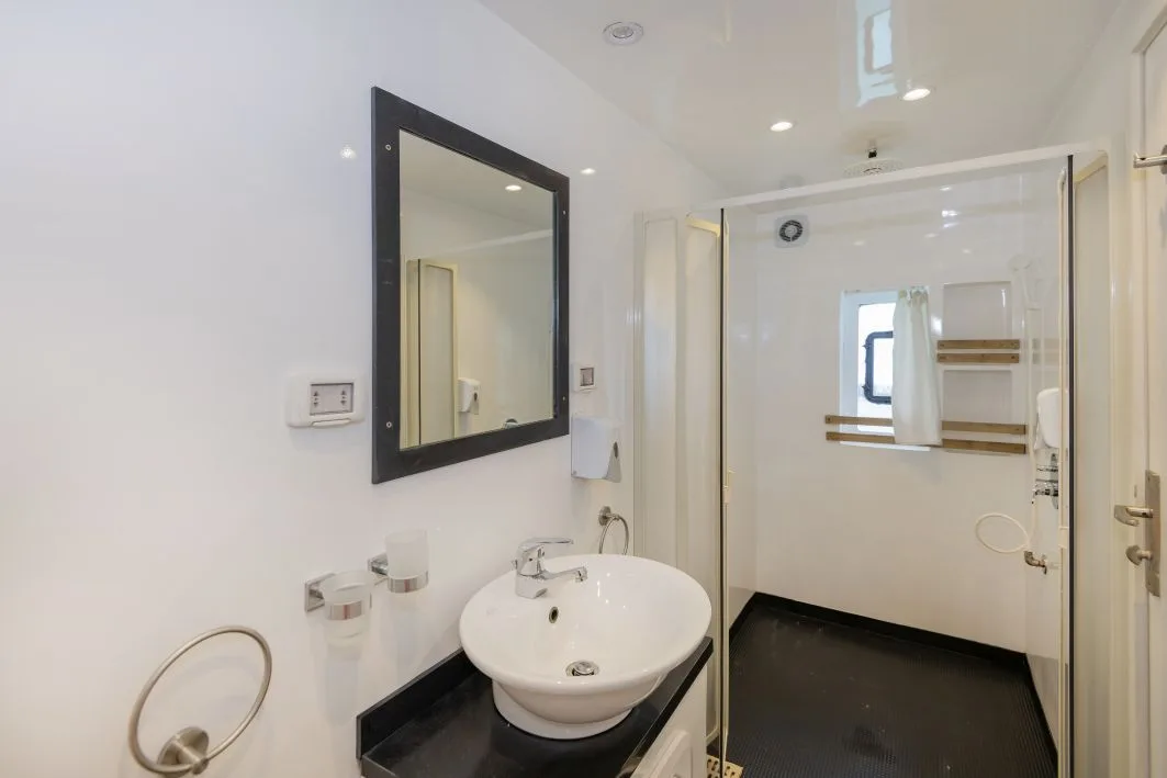Superior cabin bathroom with shower, basin and mirror