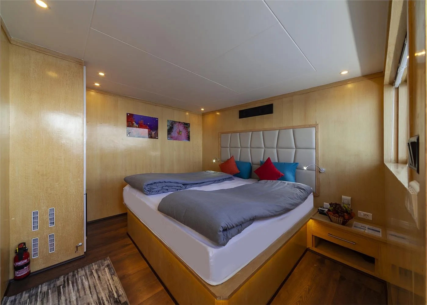 Superior upper deck cabin with a double bed and lit headboard