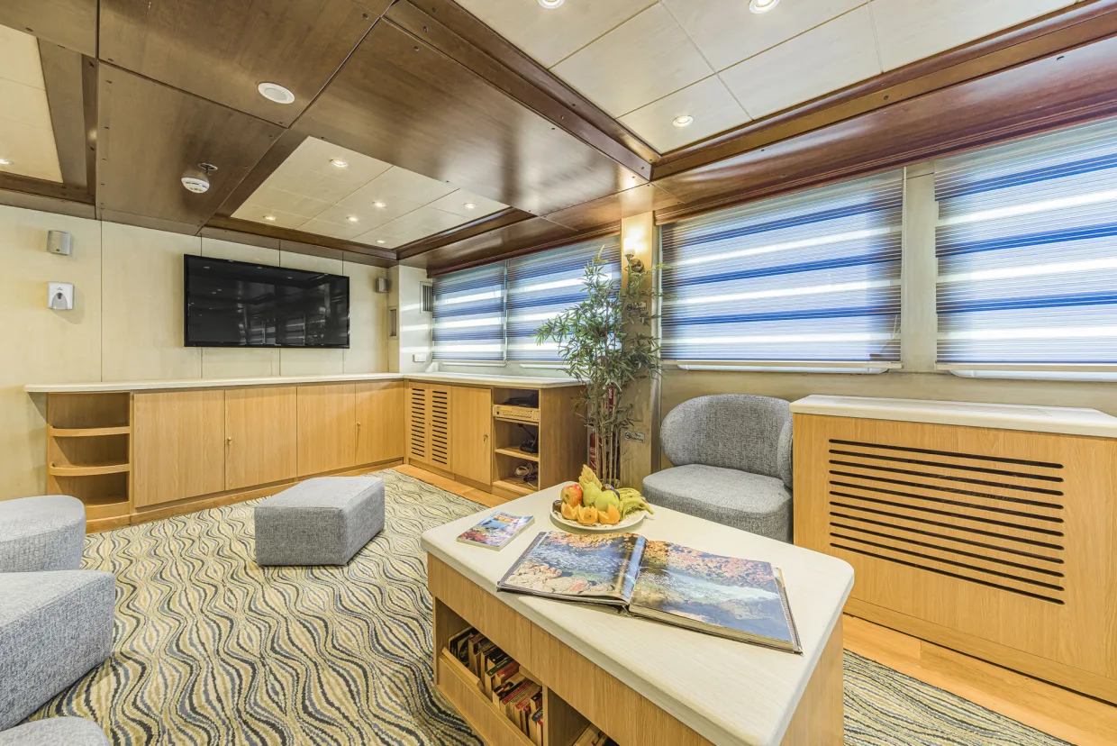The saloon on Royal Evolution with soft sofas and a large screen