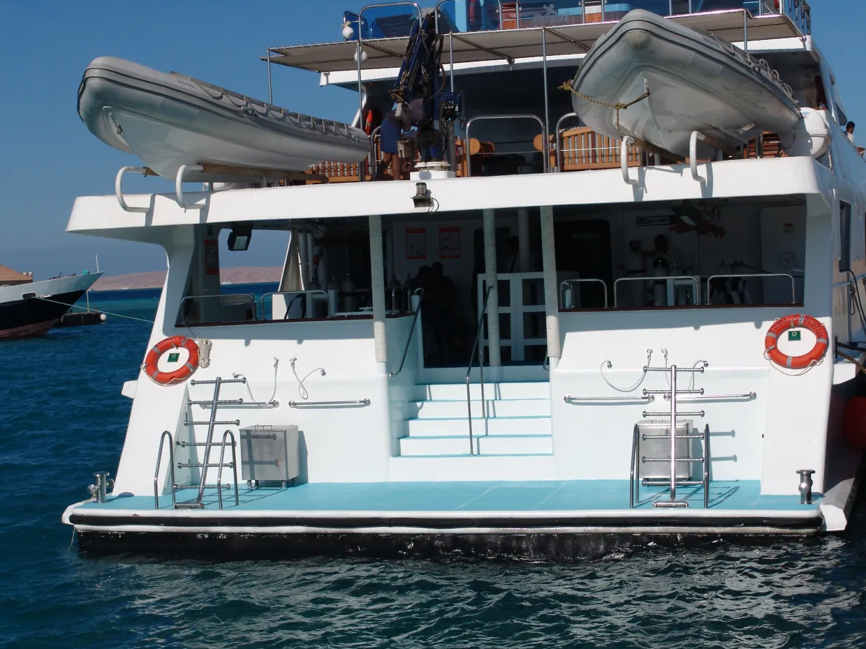 The dive platform of Royal Evolution at water level, tenders stowed above
