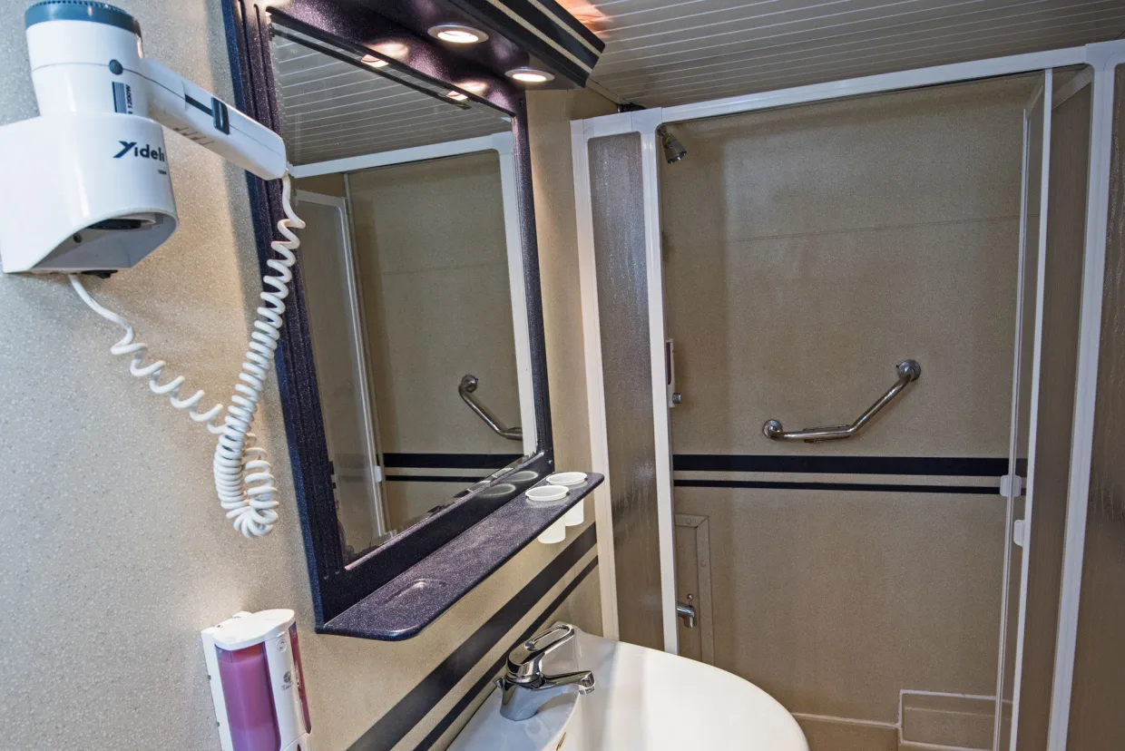 Standard cabin bathroom on Royal Evolution — shower cubicle, mirror and hairdryer