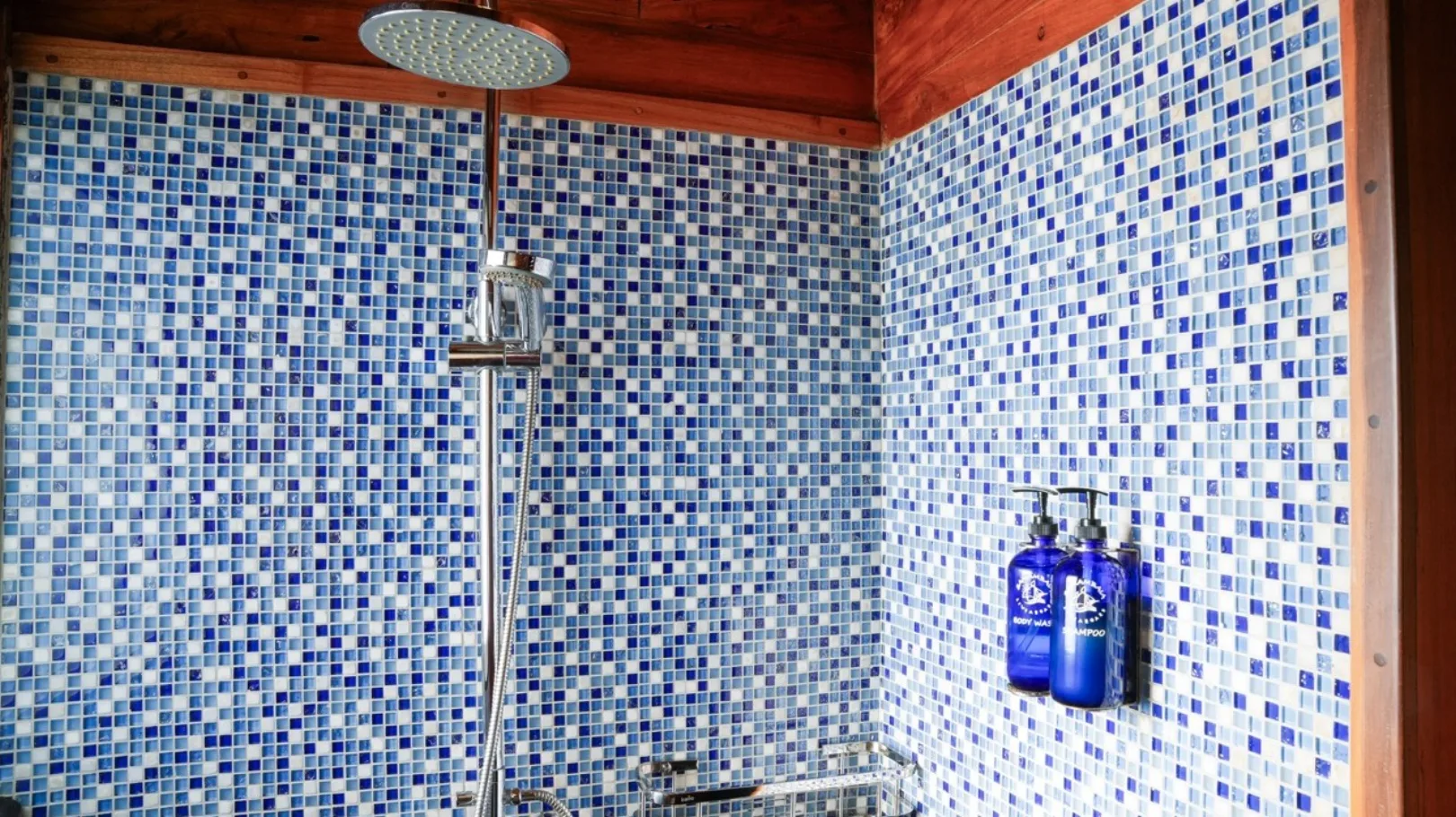 Master cabin bathroom with mosaic tiling and a rain shower