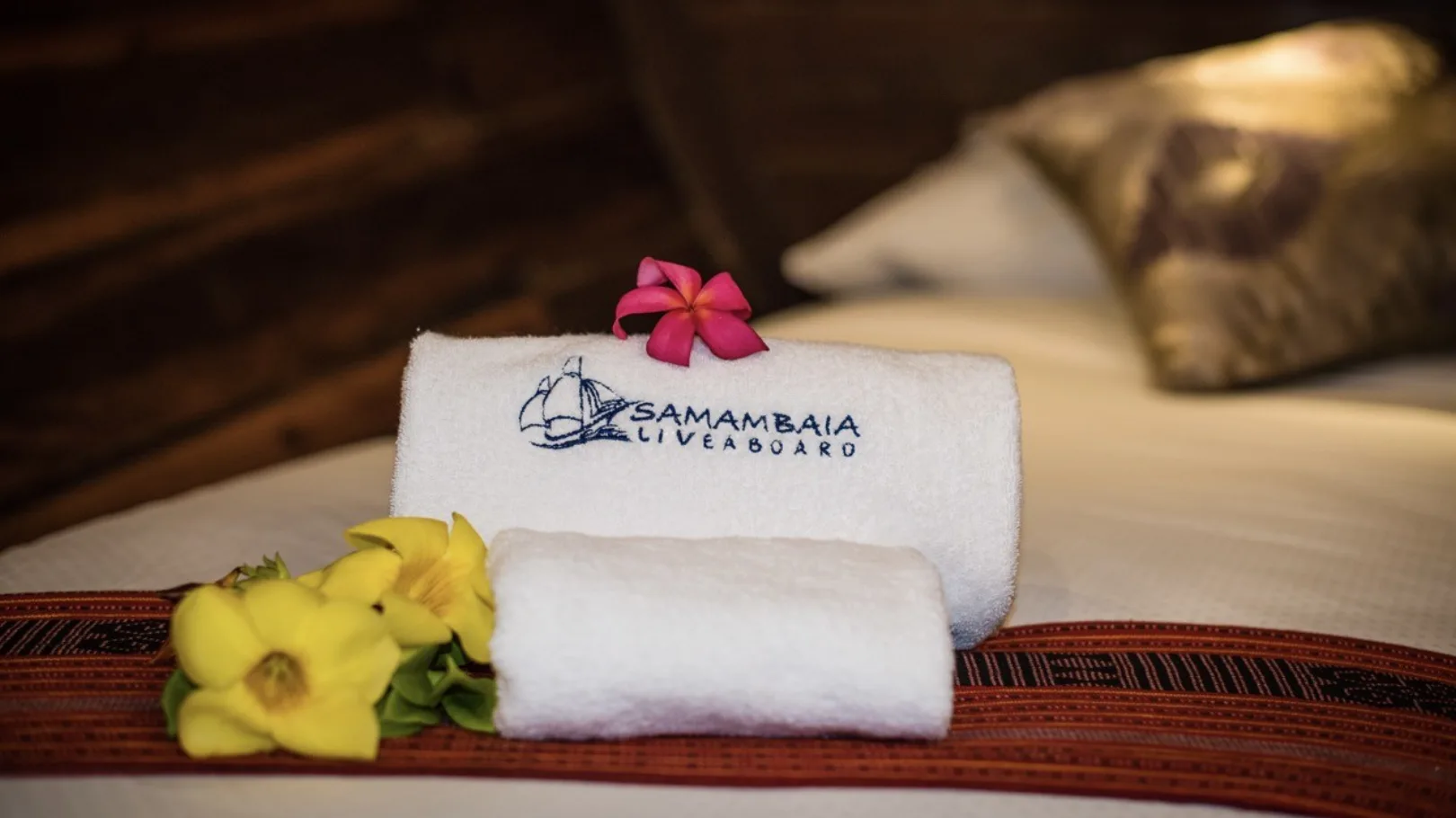 Towels embroidered with the vessel's name and a frangipani flower