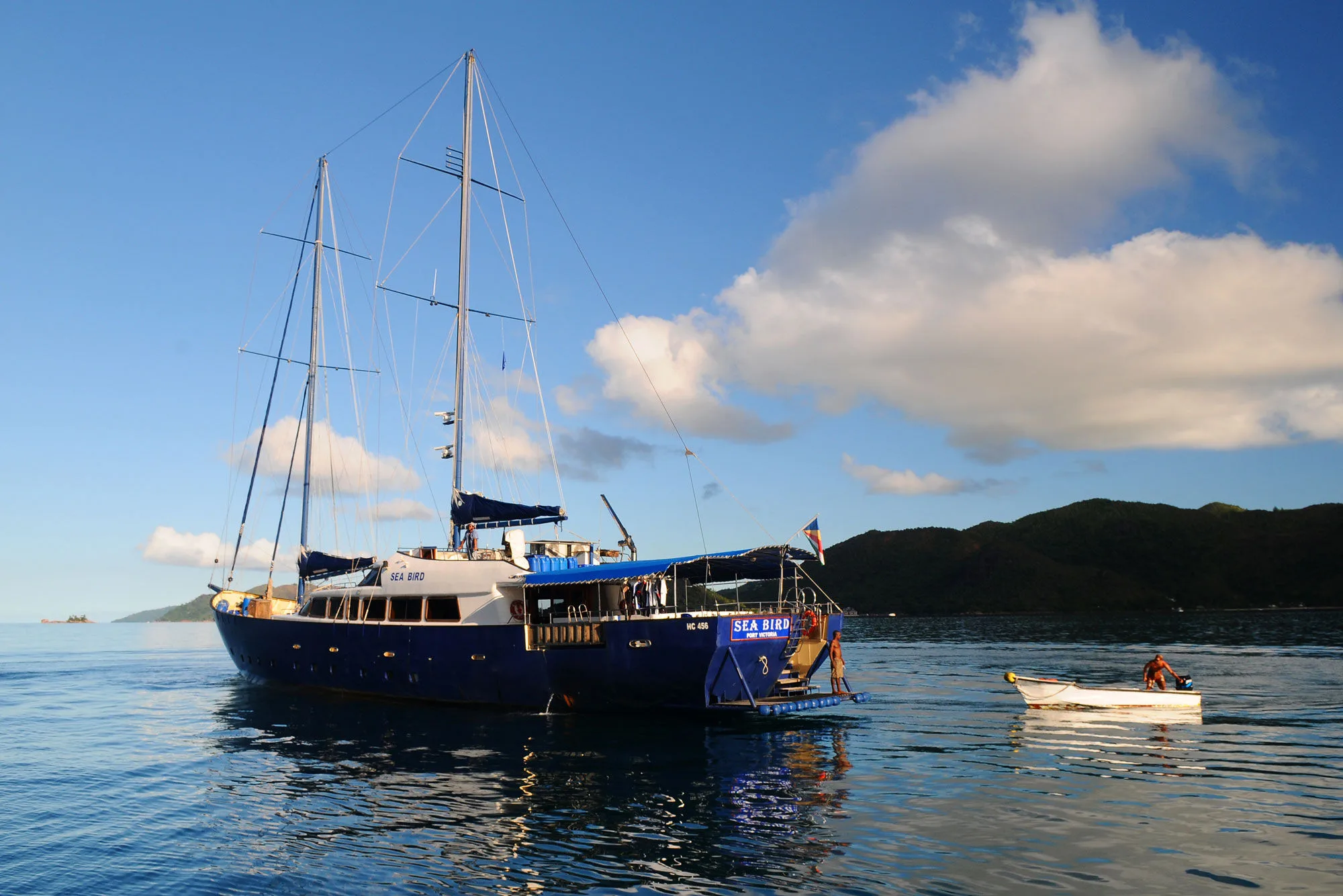 Sea Bird at anchor with the tender running ashore