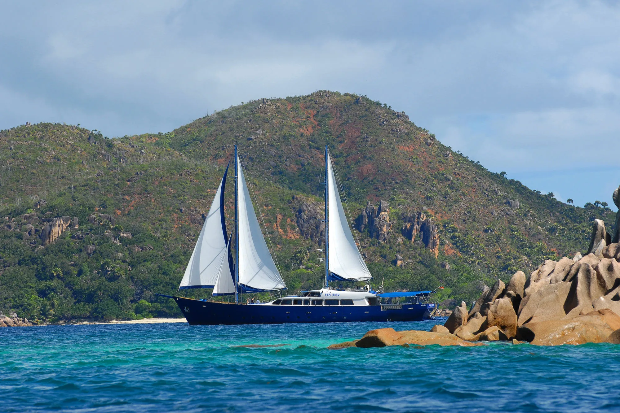 White sails against the granite cliffs