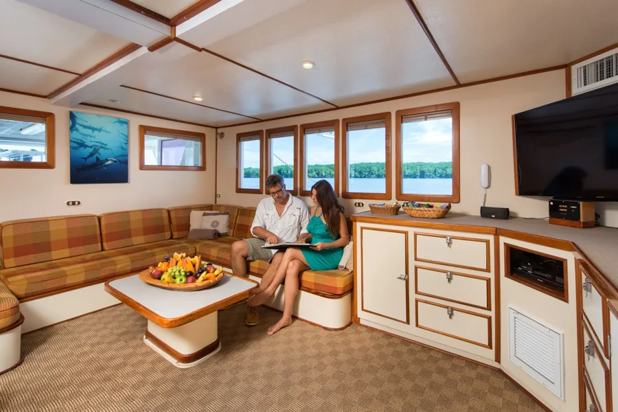Soft sofas in the saloon beside the portholes