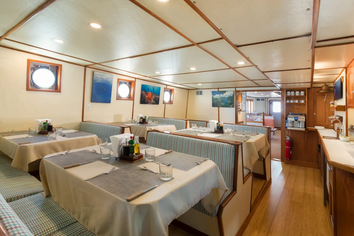 Sea Hunter's dining room — five booths laid for a meal