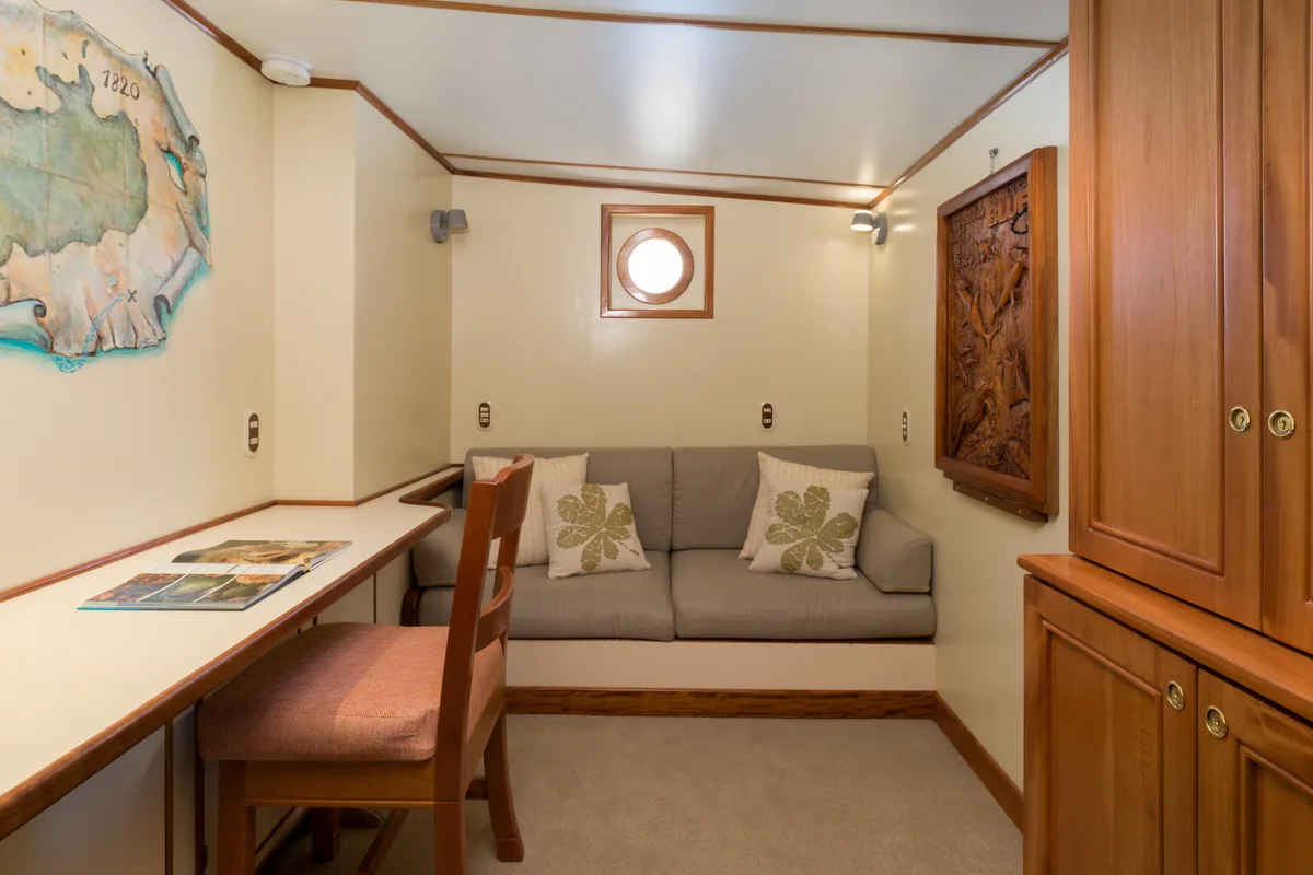 Work corner with a sofa and a map of Cocos Island on the wall