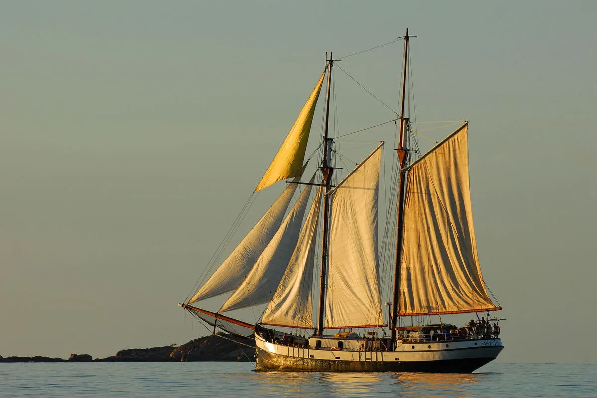 Sea Pearl at sunset with her canvas lit by the low sun