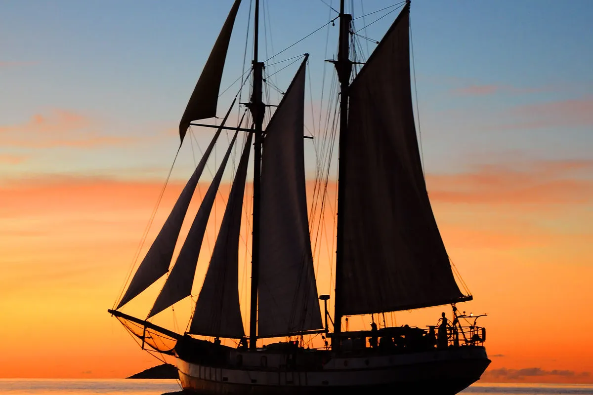 The schooner at sunset, reflected in a still sea