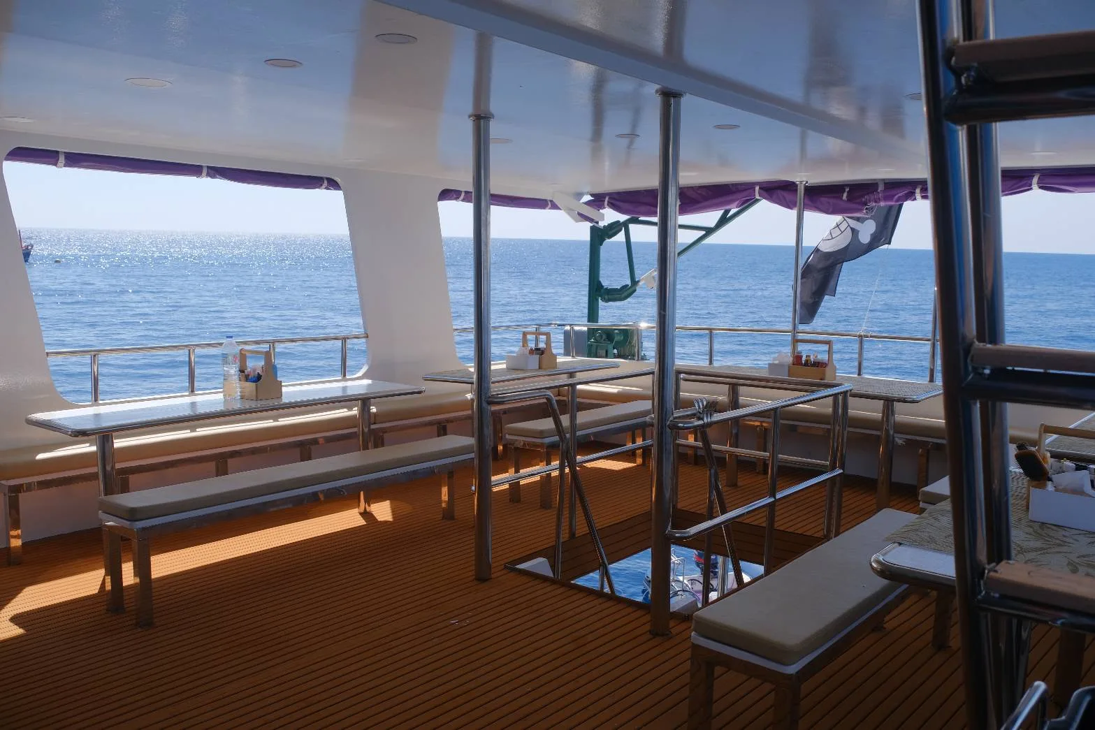 Tables and benches in the dining area looking out to sea