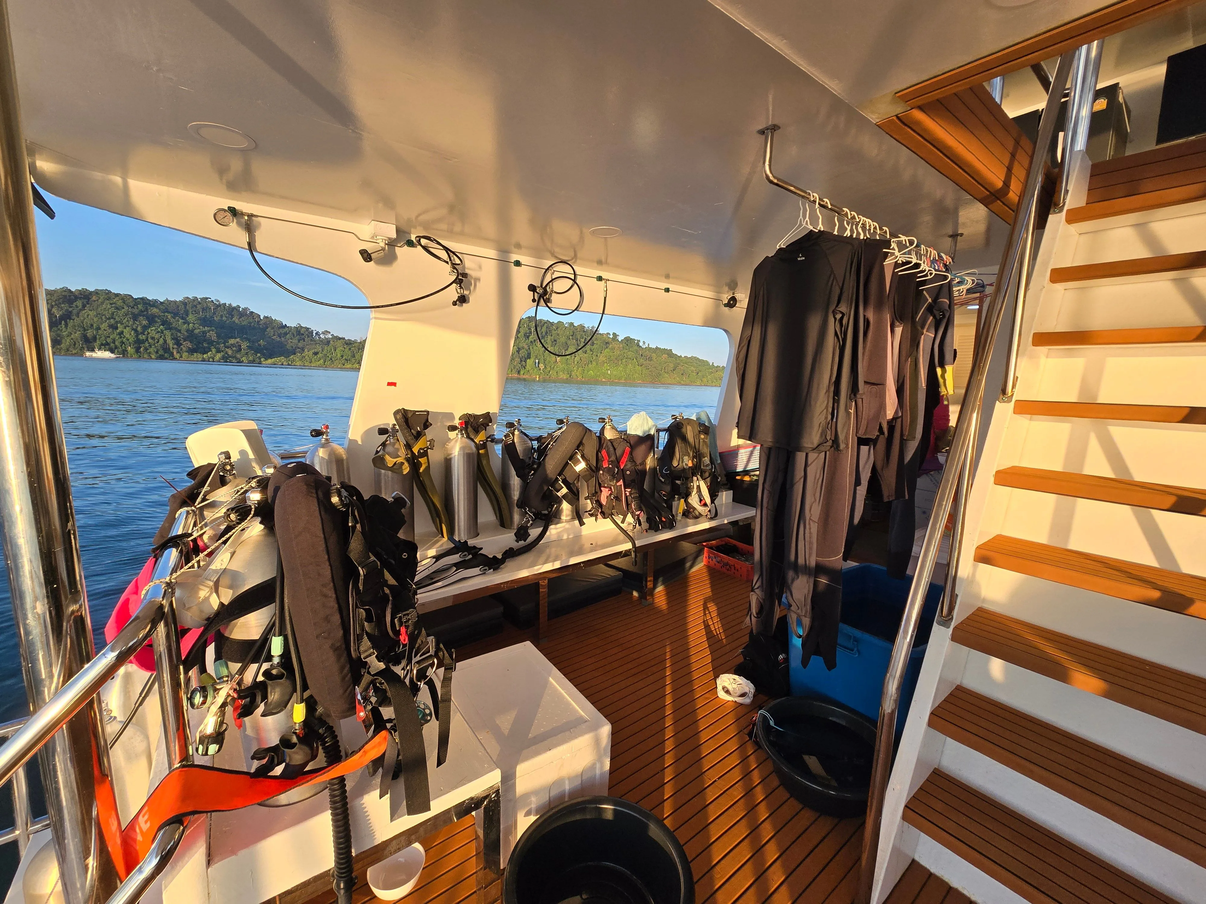 Dive deck on Seatopia — BCDs on racks and a wetsuit drying rail