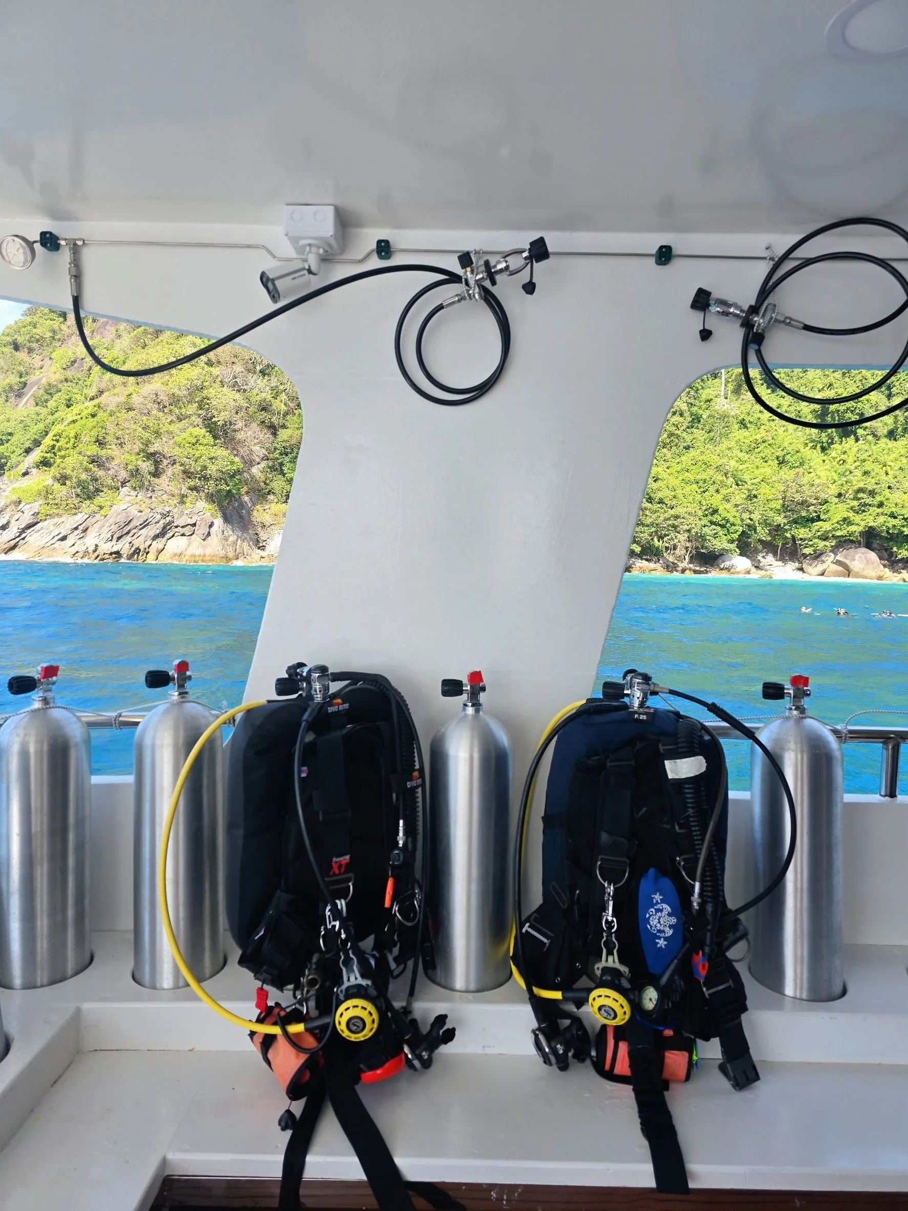 Tanks and BCDs lined up along the rail on Seatopia's dive deck
