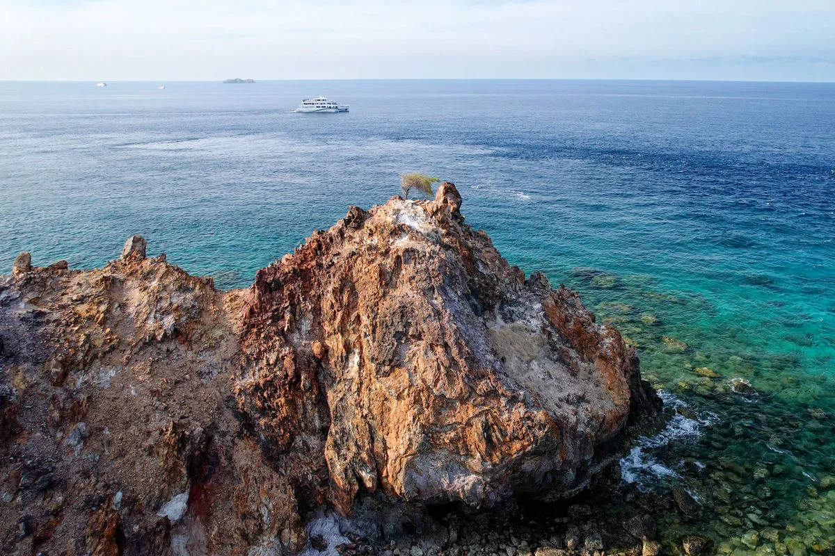 Solitude Gaia at anchor, seen from a rock